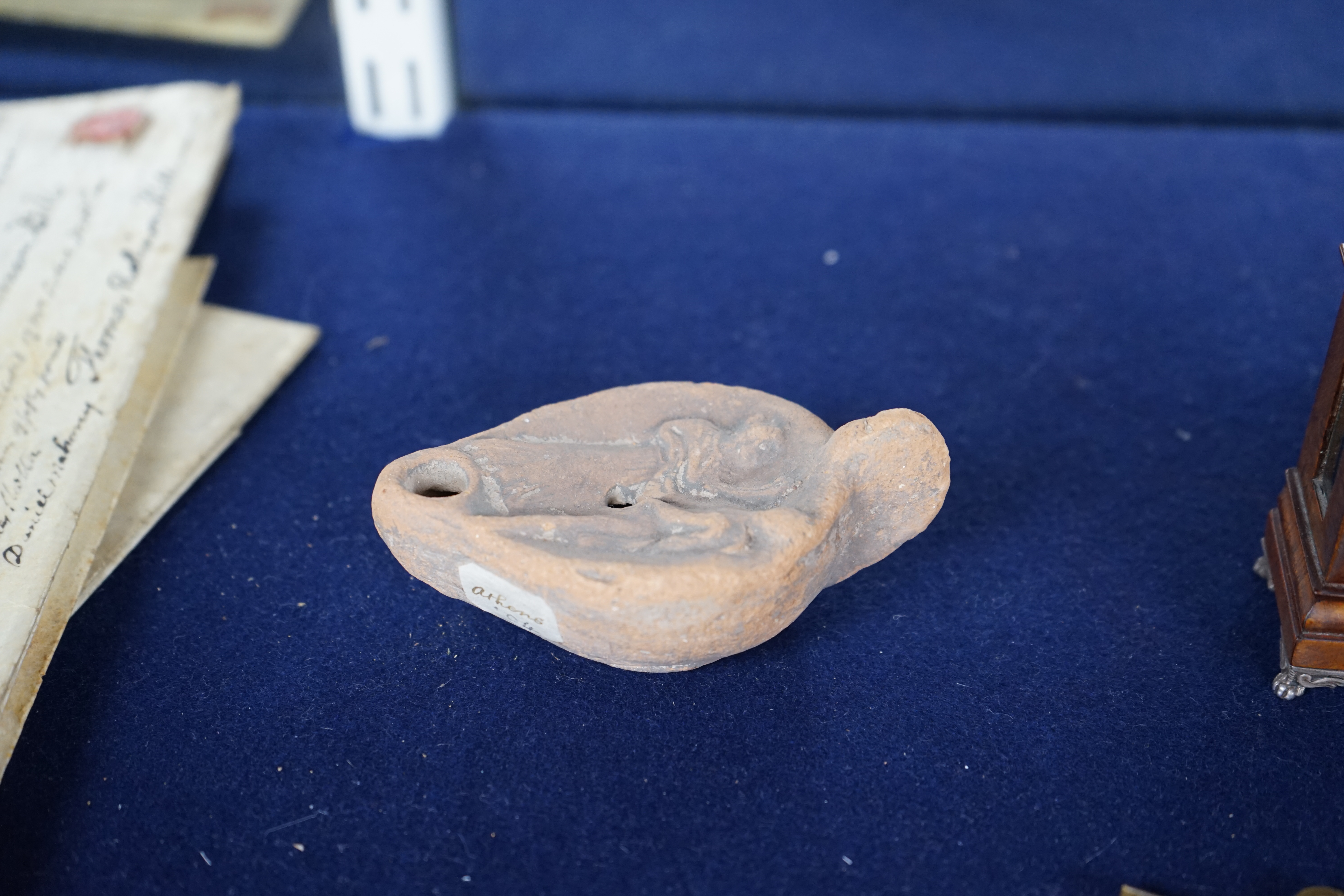 An Ancient Greek 'Athens' terracotta oil lamp, 10cm. Condition - fair